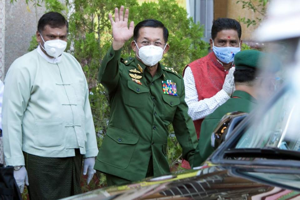 Myanmar's commander-in-chief Senior General Min Aung Hlaing (C) waves to journalists after visiting the Sri Sri Durga Bari Hindu temple in Yangon on December 24, 2020.<span class="copyright">Sai Aung Main—AFP/Getty Images</span>