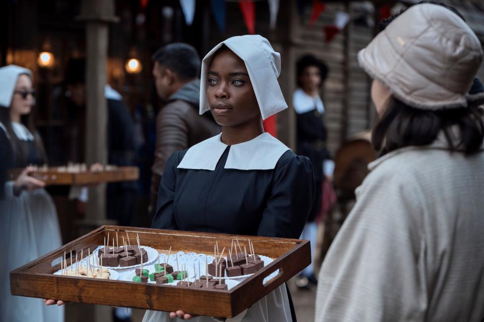 Bianca Barclay (Joy Sunday), a siren student at Nevermore, offers free fudge samples at Pilgrim World as part of Outreach Day.<span class="copyright">Vlad Cioplea—Netflix</span>