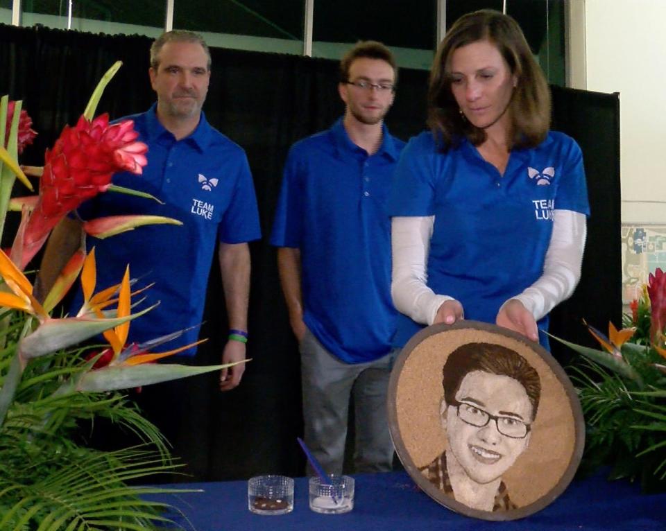 Luke Bautista’s father Christopher, brother CJ and mother Carla put the finishing touch on his ‘floragraph’ during a ceremony at Jersey Shore University Medical Center in Neptune Wednesday evening, November 15, 2017.  After his death at age 15, his organ donation saved five people and his image will be part of the Rose Bowl Donate Life float.