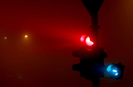 Traffic lights are seen as evening fog and air pollution covers Skopje, Macedonia December 14, 2017. REUTERS/Ognen Teofilovski