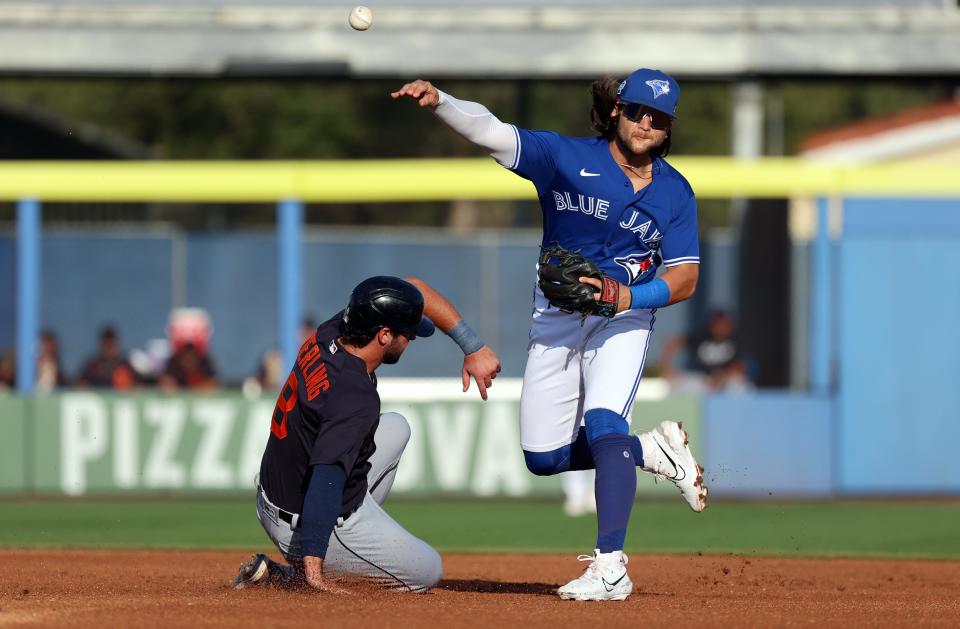 Toronto Blue Jays shortstop Bo Bichette (11) forces out Detroit Tigers outfielder Matt Vierling (8) and throws the ball to first base for a double play during the first inning at TD Ballpark in Dunedin, Florida, on Saturday, March 25, 2023.