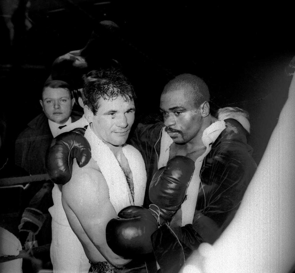 FILE - In this Feb. 23, 1965 file photo, Rubin "Hurricane" Carter and Italian boxer Fabio Bettini pose after a fight at the Palais des Sports in Paris. Carter, who spent almost 20 years in jail after twice being convicted of a triple murder he denied committing, died at his home in Toronto, Sunday, April 20, 2014, according to long-time friend and co-accused John Artis. He was 76. (AP photo/Bedini, File)