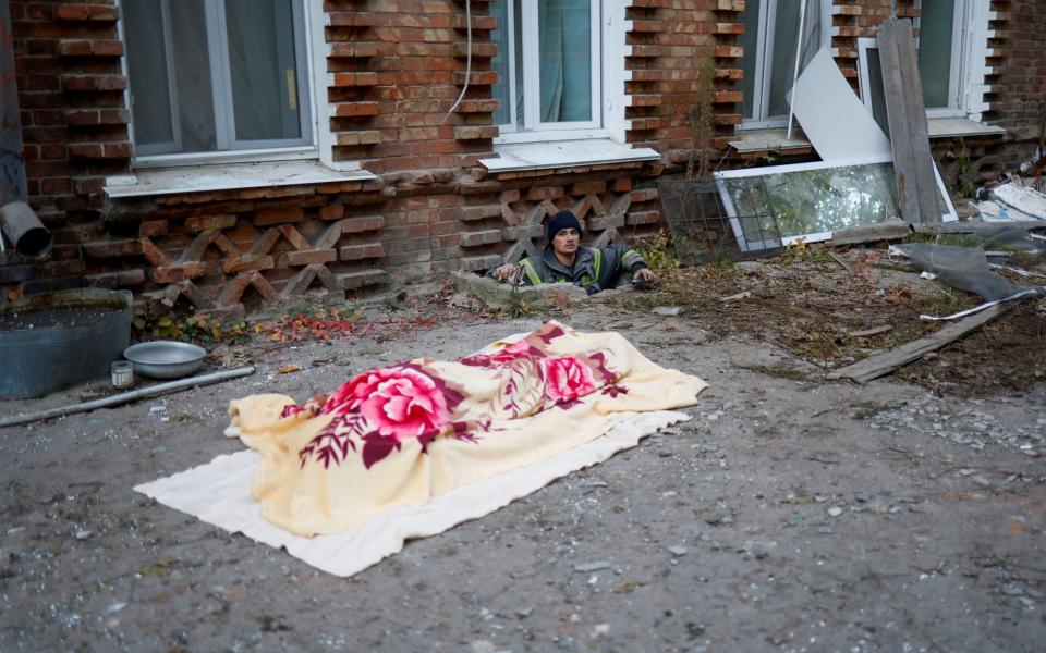 The body of a killed man is seen at a site of a residential building heavily damaged by a Russian missile strike in Mykolaiv -  VALENTYN OGIRENKO/REUTERS