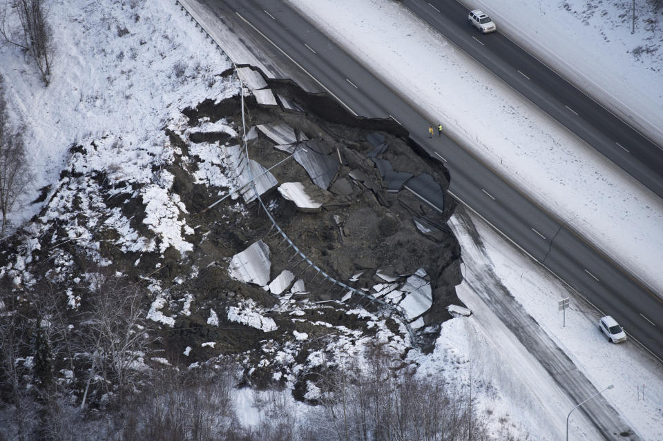 This aerial photo shows damage at the Glenn Highway near Mirror Lake after earthquakes in the Anchorage area, Alaska, Friday, Nov. 30, 2018. Back-to-back earthquakes measuring 7.0 and 5.7 shattered highways and rocked buildings Friday in Anchorage and the surrounding area, sending people running into the streets and briefly triggering a tsunami warning for islands and coastal areas south of the city. (Marc Lester/Anchorage Daily News via AP)