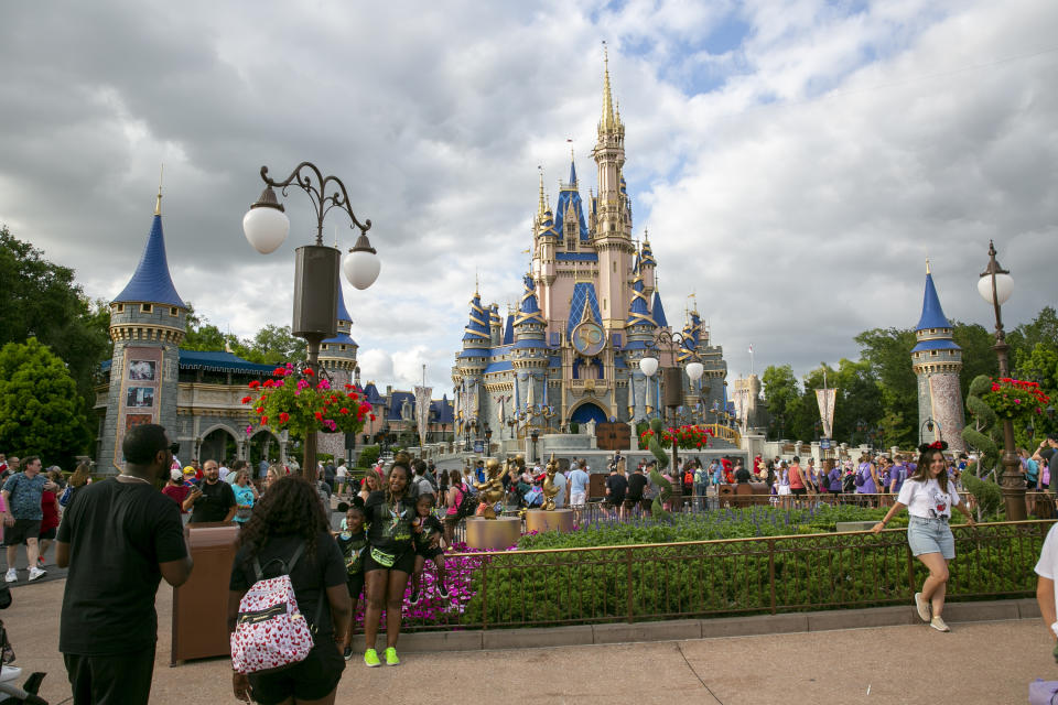 FILE - People visit Magic Kingdom Park at Walt Disney World Resort in Lake Buena Vista, Florida, on Friday, April 22, 2022. Florida lawmakers are meeting to complete a state takeover of Walt Disney World’s self-governing district and expand a migrant relocation program. The GOP-controlled Legislature is returning to Tallahassee on Monday, Feb. 6, 2023 for a special session that is expected to deliver key conservative priorities of Republican Gov. Ron DeSantis ahead of his anticipated White House run in 2024. (AP Photo/Ted Shaffrey, File)