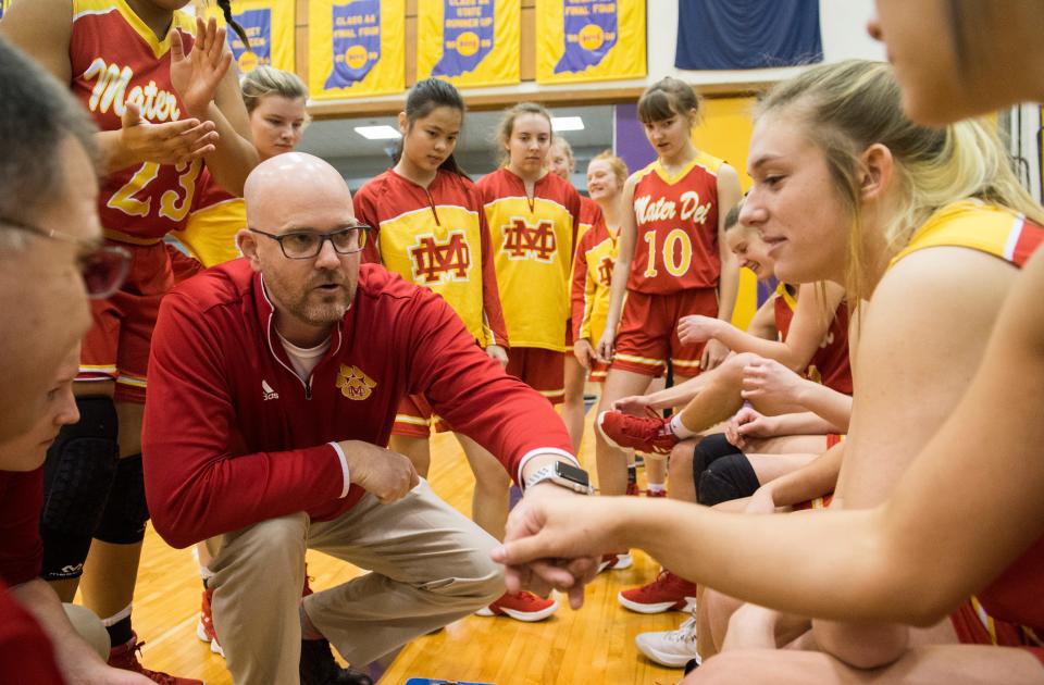 Mater Dei Head Coach Chad Breeden fist bumps the starters before the IHSAA Class 2A Girls' Basketball Regional #12 game against the South Ripley Raiders at Paoli Jr. Sr. high school Saturday, Feb. 9, 2019. Mater Dei Won, 39-23. 