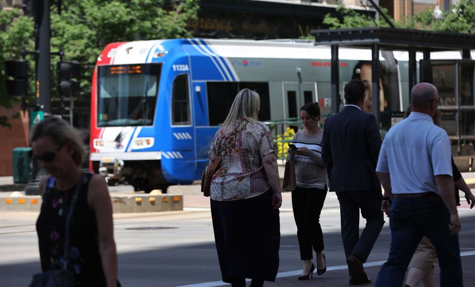 Pedestrians walk on Main Street as a TRAX train goes by in Salt Lake City on Wednesday, May 31, 2023. | Jeffrey D. Allred, Deseret News