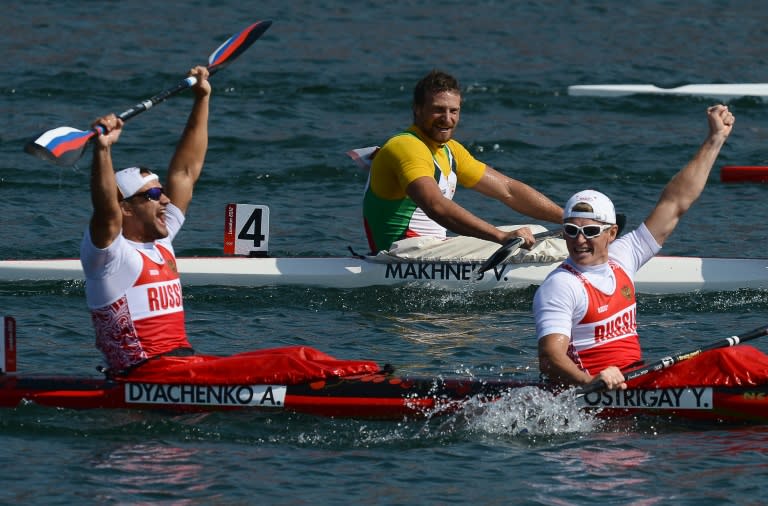 Russia's Yury Postrigay (R) and Alexander Dyachenko celebrating after winning the gold medal in the kayak double (K2) 200m men's final A during the London 2012 Olympic Games, at Eton Dorney Rowing Centre in Eton, west of London on August 11, 2012