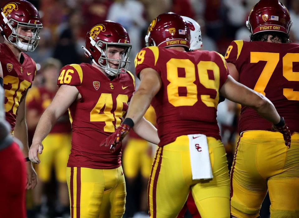 USC kicker Denis Lynch is congratulated by teammates after completing a field goal against Fresno State.