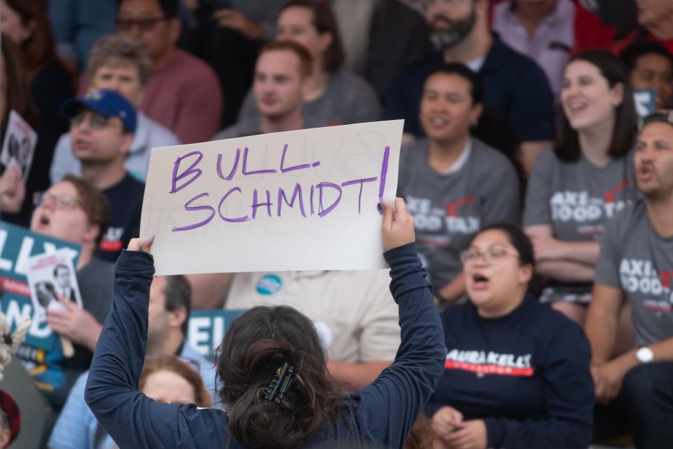 A women holds a sign to get Laura Kelly supporters to yell "Bull Schmidt" during Saturday's debate at the Kansas State Fair in Hutchinson.