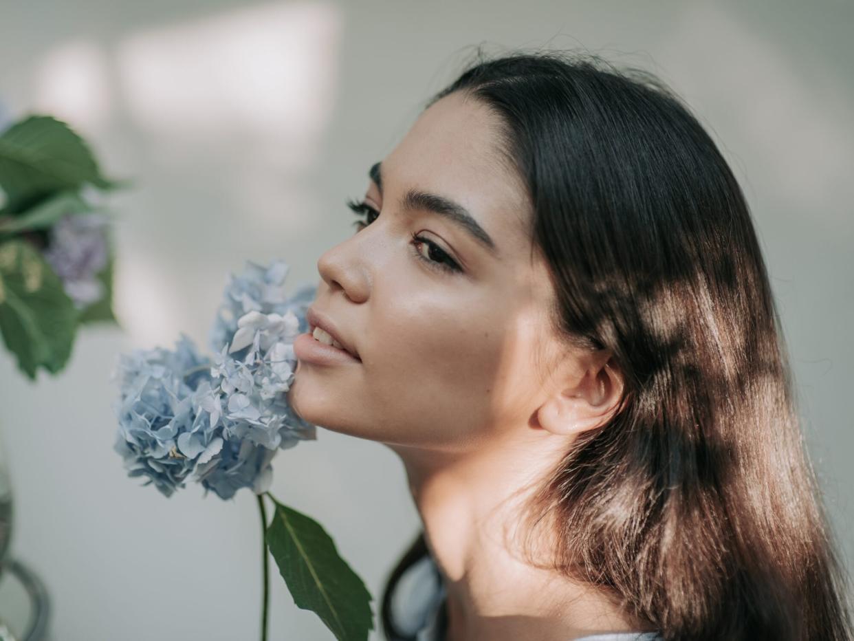 Close-Up Portrait Of A Young Woman with a flower