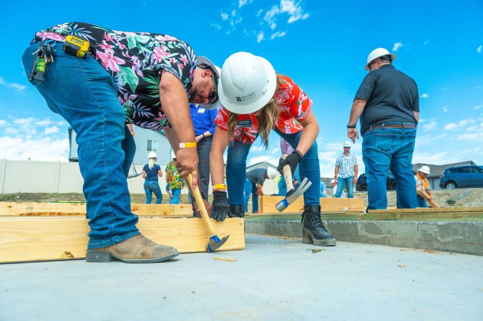 Volunteers prepare to raise the first wall of the future home of Avonlea and Buck Ide in River North, a Hayden Homes community in Benton City. The Ide family was selected to participate in First Story, which offers homebuyers a new, move-in ready home with zero down and a zero-interest, 30-year mortgage.