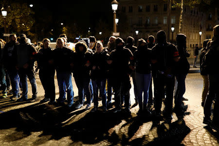 Police officers gather during an unauthorised protest against anti-police violence on the Champs Elysees in Paris, France, early October 20, 2016. REUTERS/Benoit Tessier