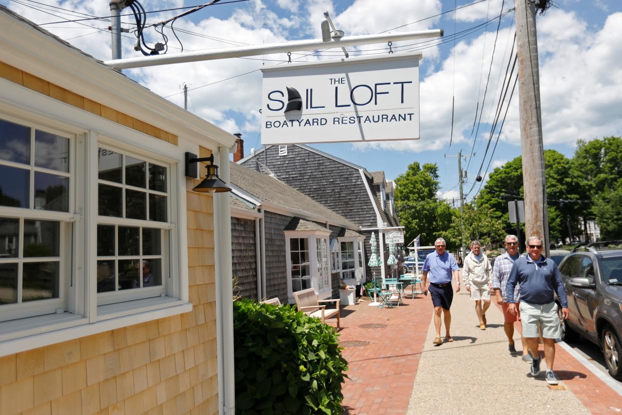 Customers walk up Elm Street toward the newly opened Sail Loft in Dartmouth.
