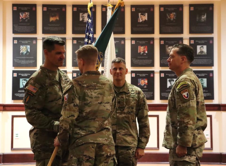 (From left) Col. Gregory Holmes assumes command of the Security Assistance Training Management Organization as he accepts the unit colors from Security Assistance Command's Brig. Gen. Brad Nicholson during a Sept. 23, 2023, change of command ceremony at Fort Liberty's Hall of Heroes.