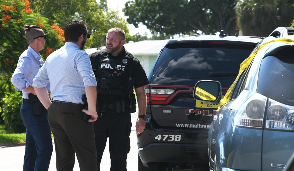 Melbourne Police and investigators on the scene of double homicide at a home on Tanglewood Lane.