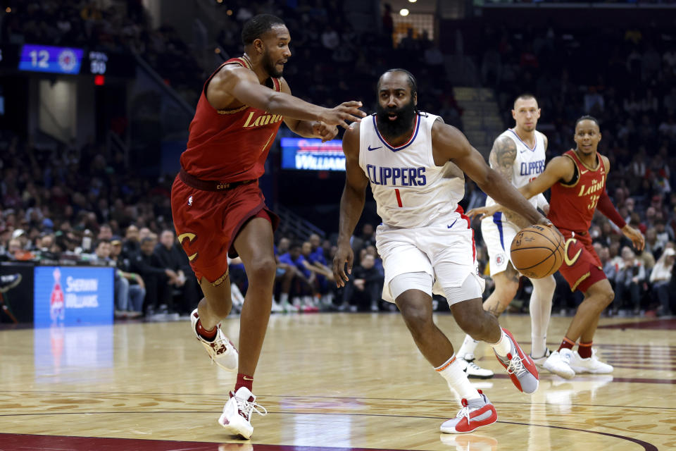 Los Angeles Clippers guard James Harden (1) drives against Cleveland Cavaliers forward Evan Mobley, left, during the first half of an NBA basketball game, Monday, Jan. 29, 2024, in Cleveland. (AP Photo/Ron Schwane)