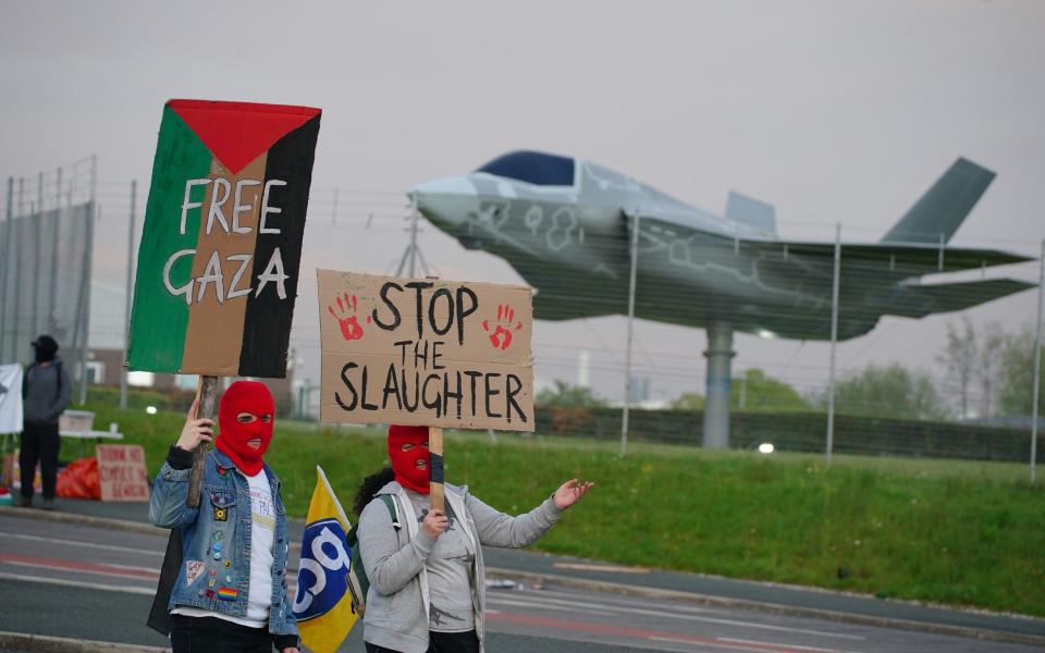 Protesters form a blockade outside weapons manufacturer BAE Systems in Samlesbury, Lancashire