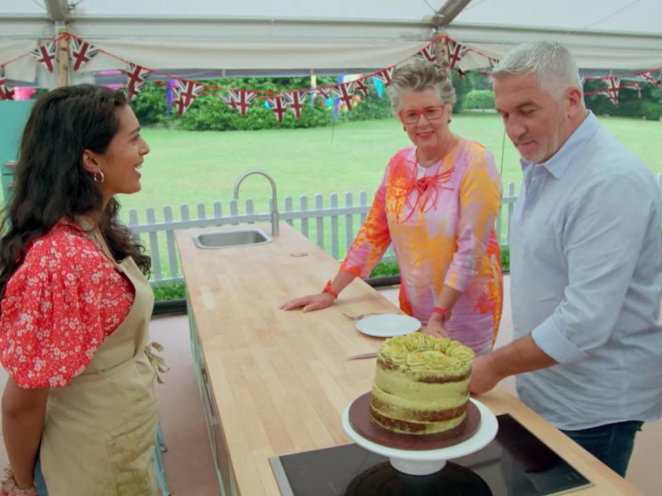 Crystelle on the great british baking show finale with paul and prue looking at her cake