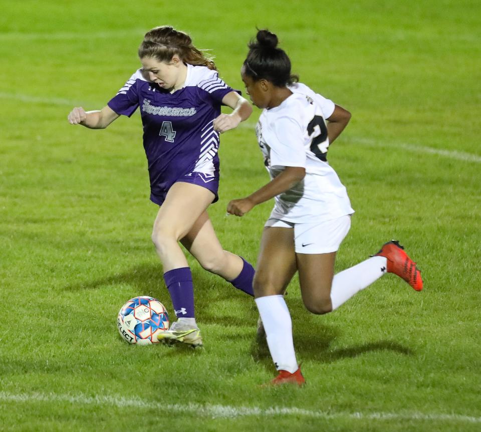 Gainesville High Schools Emma Ferrell (4) plays the ball against Buchholz High School Amari Ransom (23) during a soccer match at Citizens Field, in Gainesville Jan 11, 2022. The Bobcats beat the Hurricanes 3-0 in the city rivalry match-up.