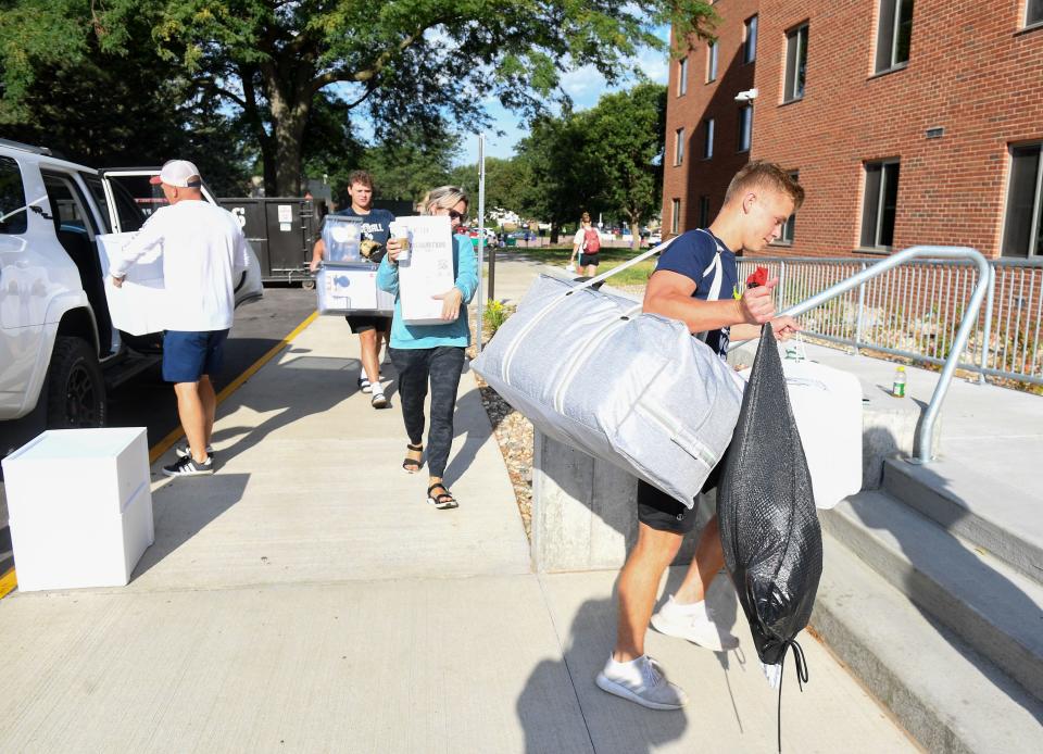 Students and their families carry items from cars into their dorm rooms on Saturday, August 27, 2022, at Augustana University in Sioux Falls.