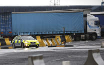 Police patrol the port of Larne, Northern Ireland, Tuesday, Feb. 2, 2021. Authorities in Northern Ireland have suspended checks on animal products and withdrawn workers from two ports after threats against border staff. (AP Photo/Peter Morrison)