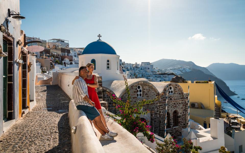 Happy romantic couple in Oia, Santorini, Cyclades, Greece