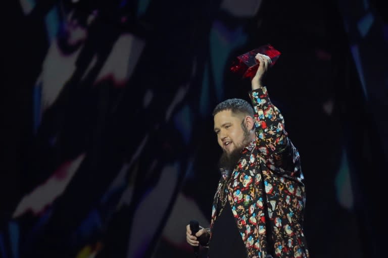 British singer-songwriter Rag'n'Bone Man celebrates with the award for British single for 'Human' during the Brit Awards 2018 ceremony in London