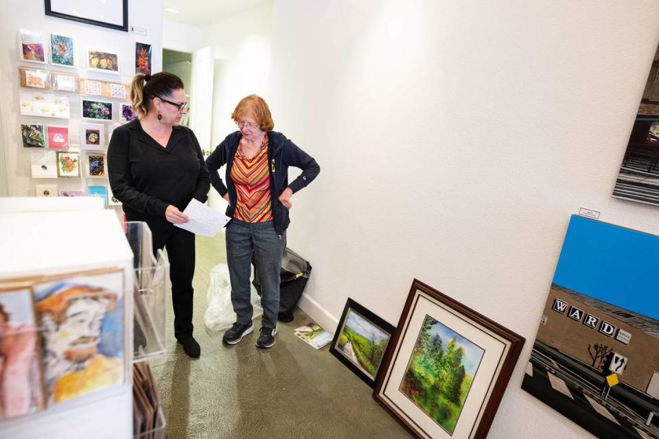 Artist Barbara Gill, right, drops off paintings with The Chartreuse Muse co-owner Sandra Veneman, left, in Modesto, Calif., Tuesday, March 26, 2024. Owners announced they would be closing the downtown gallery and art school after one last show that will run through May.