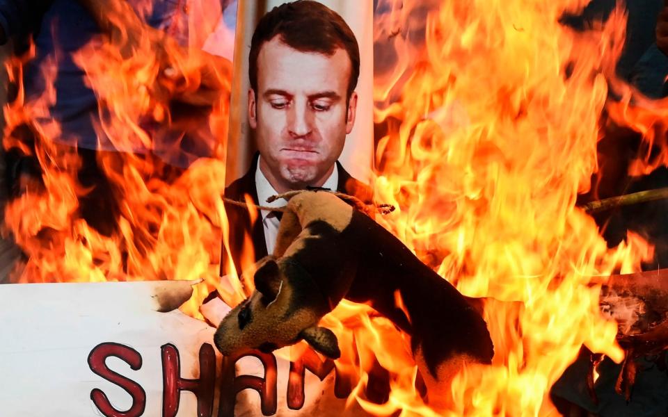 Protesters burn an effigy of French President Emmanuel Macron during an anti-France demonstration in Kolkata on November 4, 2020.  -  DIBYANGSHU SARKAR/AFP