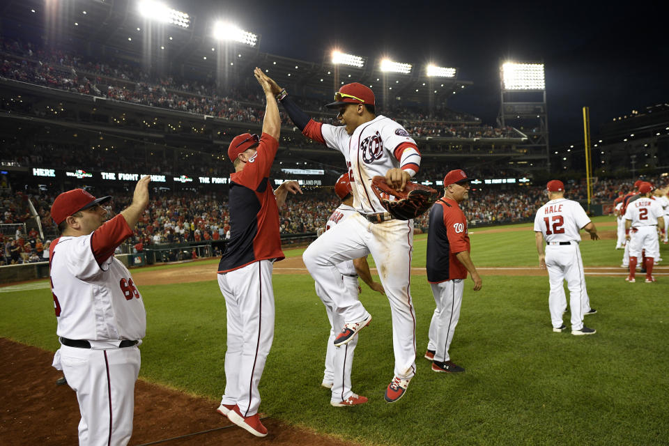 Washington Nationals' Juan Soto, center, leaps to celebrate after a baseball game against the Cleveland Indians, Saturday, Sept. 28, 2019, in Washington. (AP Photo/Nick Wass)