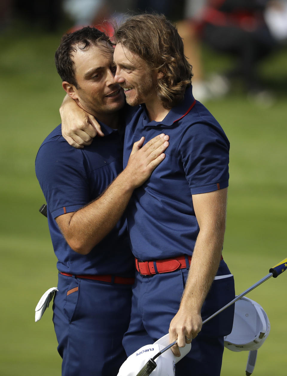 Europe's Francesco Molinari, left, and Europe's Tommy Fleetwood embrace after beating Tiger Woods of the US and Patrick Reed in their fourball match on the opening day of the 42nd Ryder Cup at Le Golf National in Saint-Quentin-en-Yvelines, outside Paris, France, Friday, Sept. 28, 2018. (AP Photo/Matt Dunham)