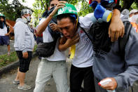 <p>Demonstrator affected by tear gas reacts while rallying against Venezuela’s President Nicolas Maduro in Caracas, Venezuela May 1, 2017. (Photo: Carlos Garcia Rawlins/Reuters) </p>