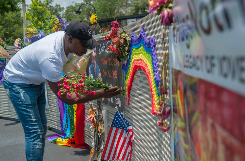 A visitor to the new interim Pulse nightclub memorial leaves flowers in Orlando Florida on June 4, 2018. (Photo: Chris McGonigal/HuffPost)