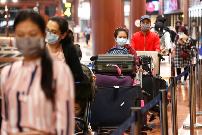 Passengers stand in line to have documents checked at a Soekarno Hatta Airport amid the coronavirus disease (COVID-19) outbreak in Jakarta