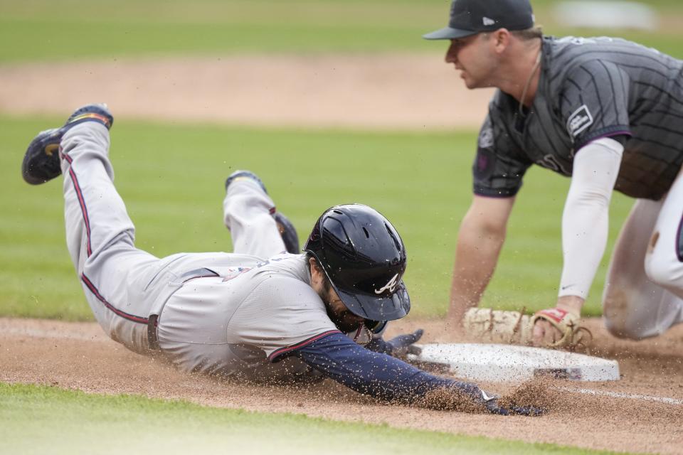 Atlanta Braves' Travis d'Arnaud, left, slides into first base during the ninth inning of a baseball game against the New York Mets, Saturday, May 11, 2024, in New York. d'Arnaud was out on the play. (AP Photo/Frank Franklin II)