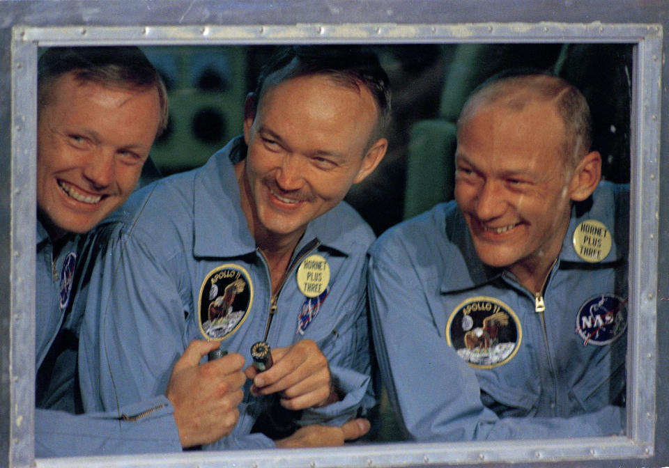 FILE - In this July 24, 1969, file photo, Apollo 11 astronauts, Neil Armstrong, left, Michael Collins, center, and Edwin "Buzz" Aldrin smile as they answer questions from quarantine in an isolation unit aboard the USS Hornet after splashdown and recovery. The Honolulu Star-Advertiser reported Wednesday, July 24, 2019, the 50th anniversary of the astronaut's return to Earth, that the crew hit the atmosphere at 25,000 mph, creating a fireball that was visible to the crew of the waiting recovery aircraft carrier USS Hornet stationed about 900 miles (1,448 kilometers) southwest of Hawaii. (AP Photo, File)