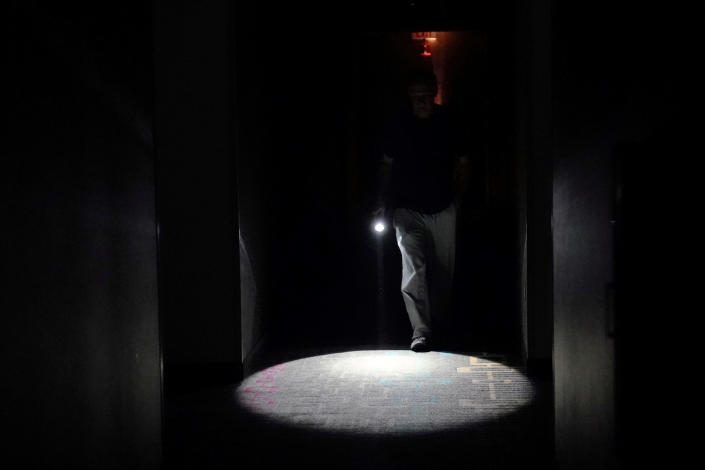 <p>A person walks down a dark hallway in a hotel lobby that has lost its power as Hurricane Florence comes ashore on Wilmington, N.C., Sept. 14, 2018. (Photo: Carlo Allegri/Reuters) </p>