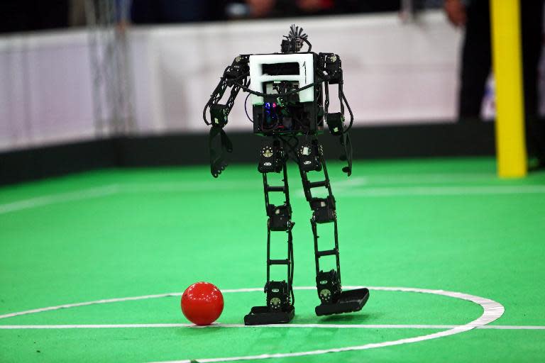 A robot of Iran's Parand Azad University prepares to kick the ball during a match against 'Mechatronics Research Laboratory; from Iran's Azad University of Qazvin, during the RoboCup Iran Open 2014, in Tehran, on April 10