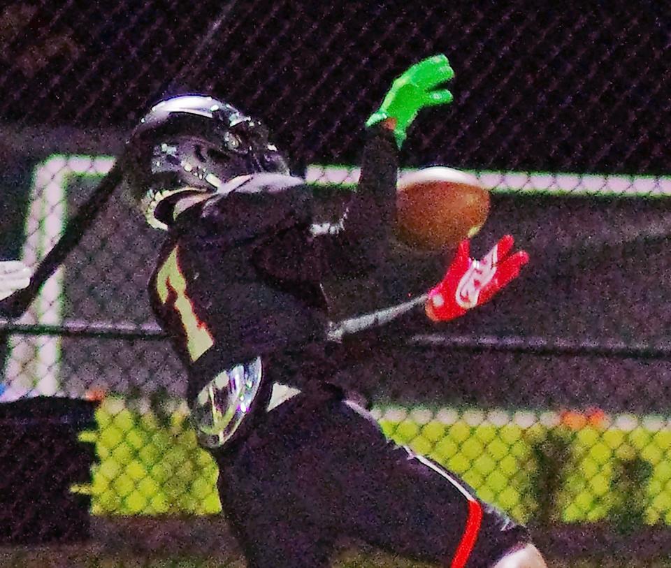 Jarred Daughtry, of the Stoughton Black Knights, hauls in an interception to stop a major Sharon Eagles threat in the first half of the football game on Thursday, Oct. 19, 2023.