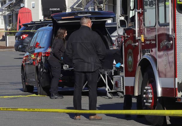PHOTO: Officials from the medical examiner's office take away a body as emergency services personnel attend the scene after a vehicle crashed into an Apple store in Hingham, Mass., Nov. 21, 2022.  (Brian Snyder/Reuters)