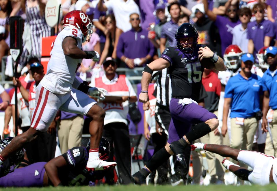 TCU quarterback Max Duggan (15) runs with the ball as Oklahoma linebacker David Ugwoegbu (2) chases during the second half of Saturday's game in Fort Worth, Texas.