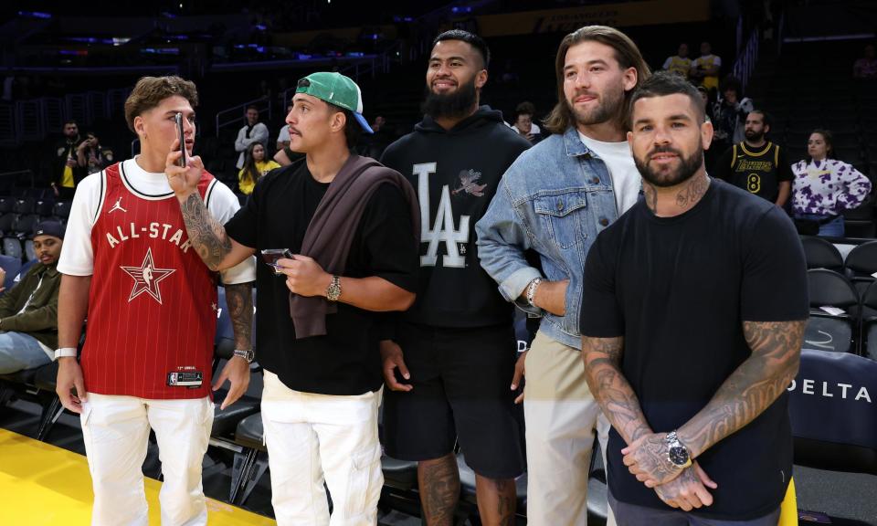 <span>Brisbane Broncos players at an NBA game on their trip to the US, where they will play the opening round of the 2024 NRL season in Las Vegas.</span><span>Photograph: Sean M Haffey/Getty Images</span>