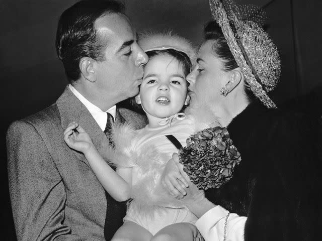 <p>KM Archive/Getty</p> Liza Minnelli with her mother, Judy Garland and father, Vincente Minnelli in Hollywood California on April 1947