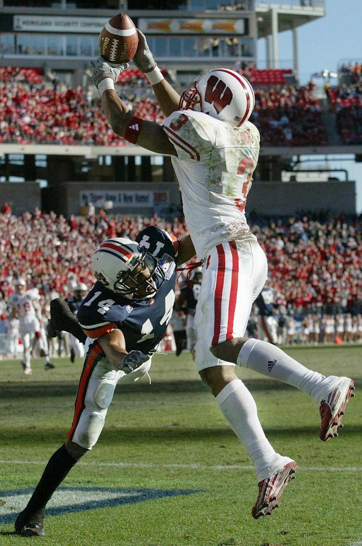 Wisconsin's Lee Evans (3) pulls in a touchdown pass over Auburn's Carlos Rogers (14) in the fourth quarter of the Music City Bowl on Wednesday, Dec. 31, 2003, in Nashville, Tenn. Auburn defeated Wisconsin 28-14.