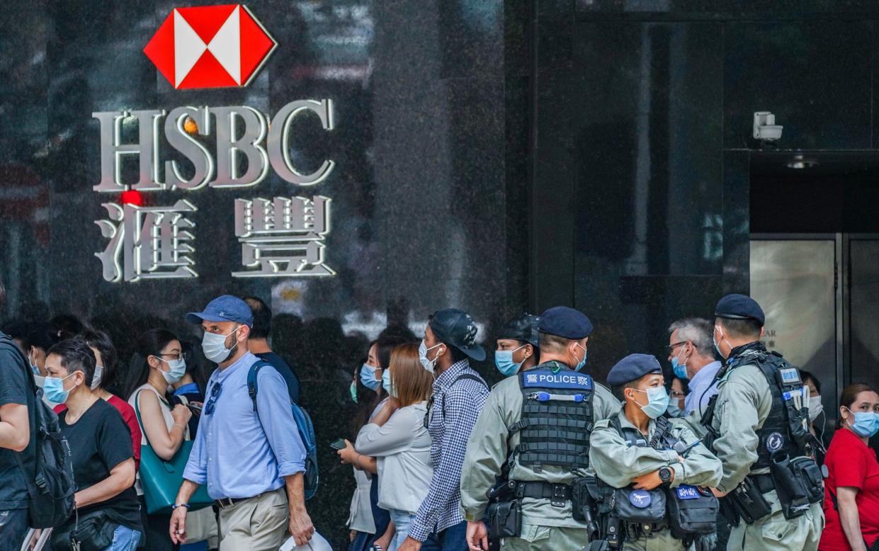 riot police outside an HSBC in Hong Kong in 2020 - Lam Yik/Bloomberg