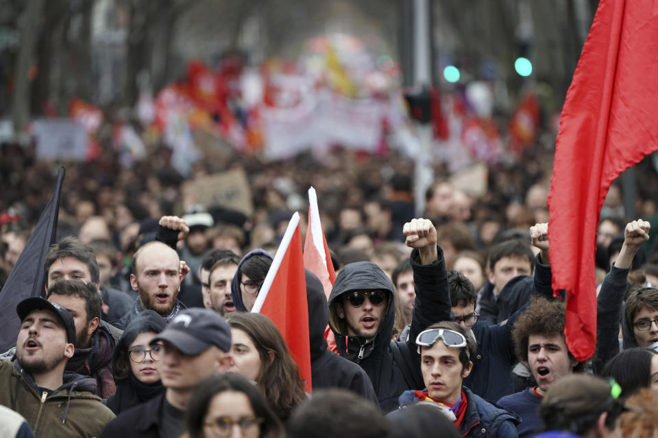 Protesters shout during a demonstration in Lyon, central France, Tuesday, Dec. 17, 2019. Workers at the Eiffel Tower, teachers, doctors, lawyers and people from across the French workforce walked off the job Tuesday to resist a higher retirement age, or to preserve a welfare system they fear their business-friendly president wants to dismantle. (AP Photo/Laurent Cipriani)