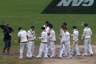 Australia's team celebrate after winning the second Ashes cricket test against England at the Adelaide Oval December 9, 2013. Australia captured England's four remaining wickets before lunch to close out an emphatic 218-run victory in the second Ashes test on Monday. REUTERS/David Gray (AUSTRALIA - Tags: SPORT CRICKET)