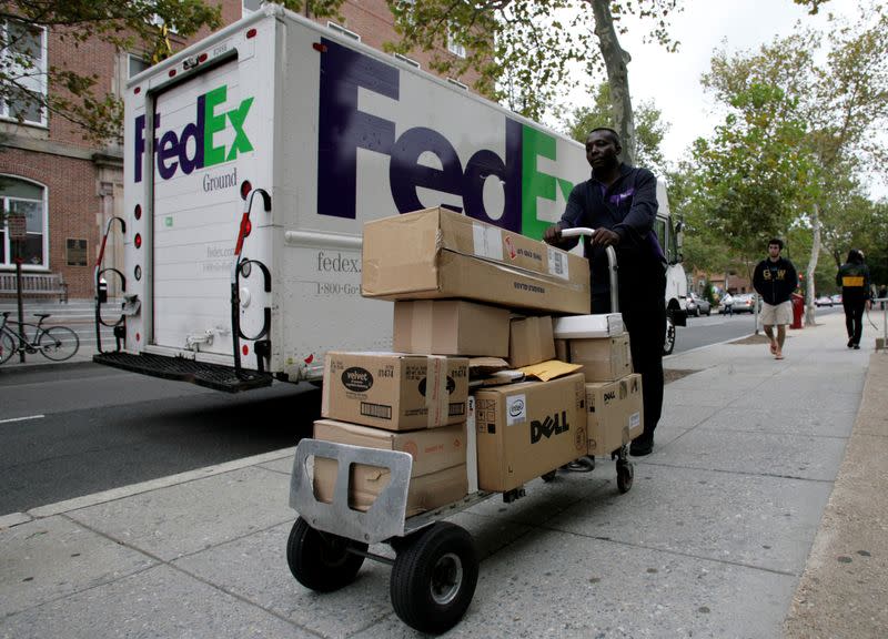 FILE PHOTO: A FedEx driver delivers packages in Washington