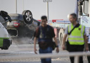 <p>Police officers walk near an overturned car onto a platform at the spot where terrorists were intercepted by police in Cambrils, Spain, Friday, Aug. 18, 2017. (Photo: Emilio Morenatti/AP) </p>